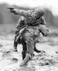 Soldier carrying wounded comrade — Never Leave Behind